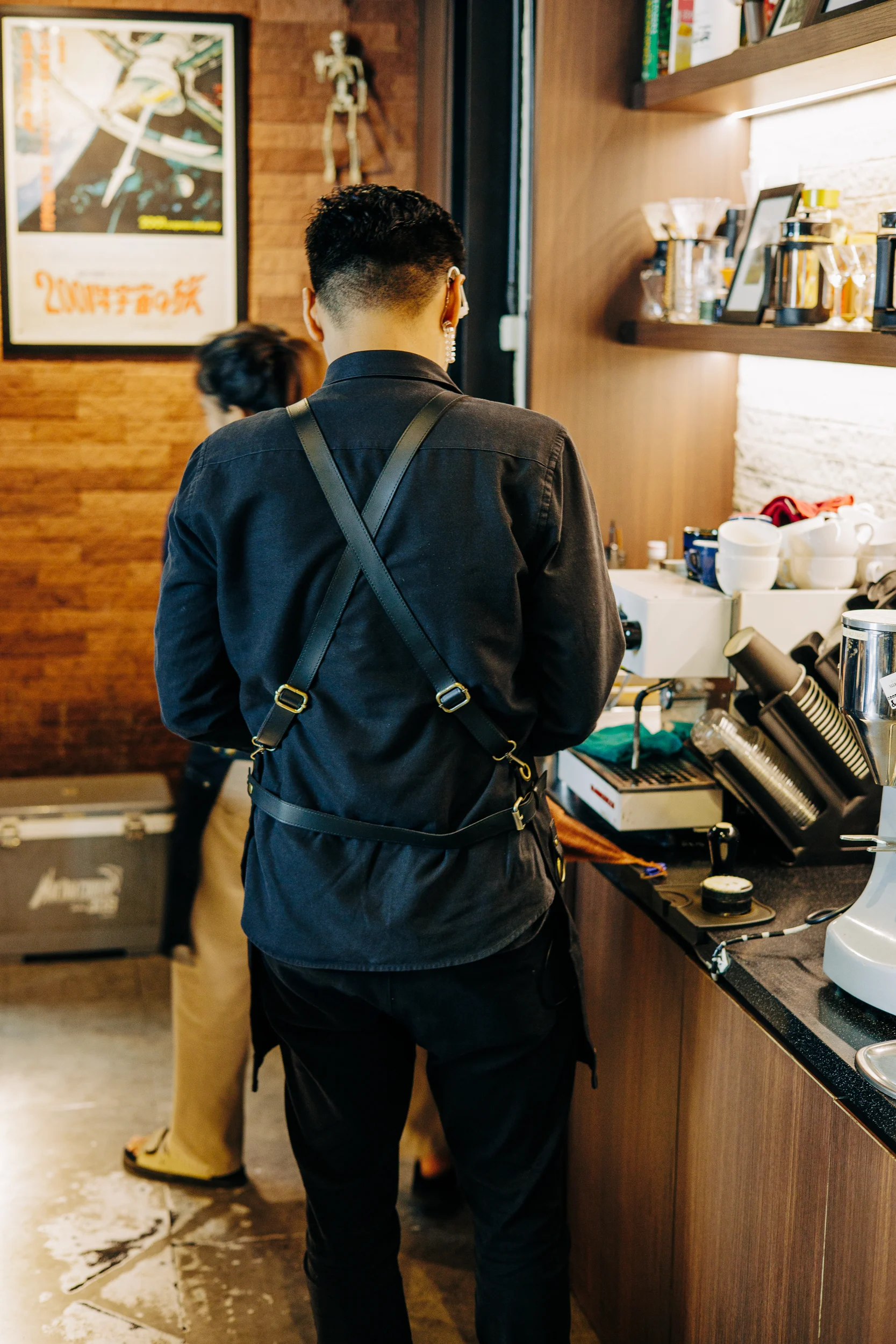 Barista préparant un café derrière le comptoir d'un coffee shop indonésien